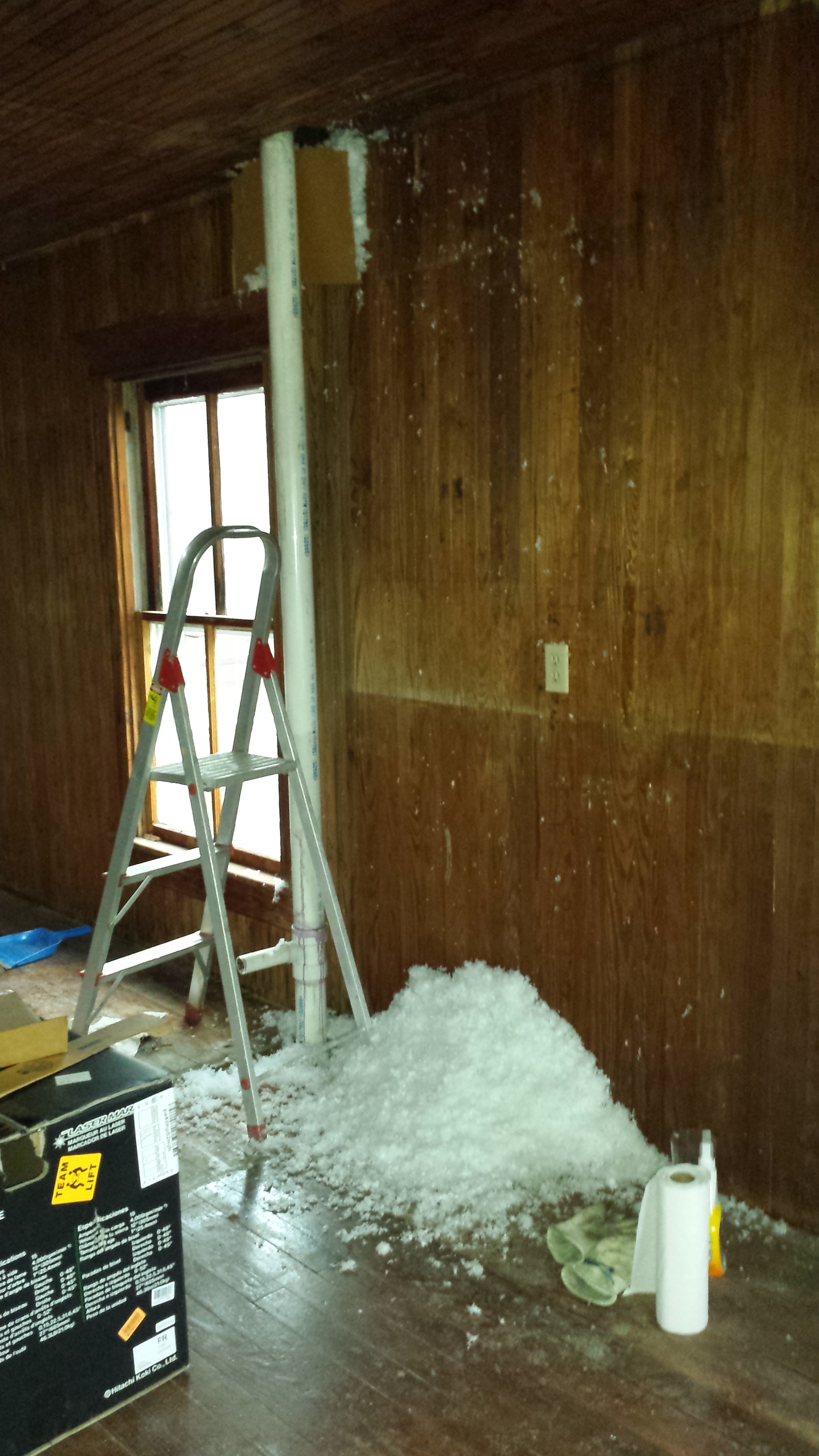 Blown insulation + hole in wall=mess on floor.
